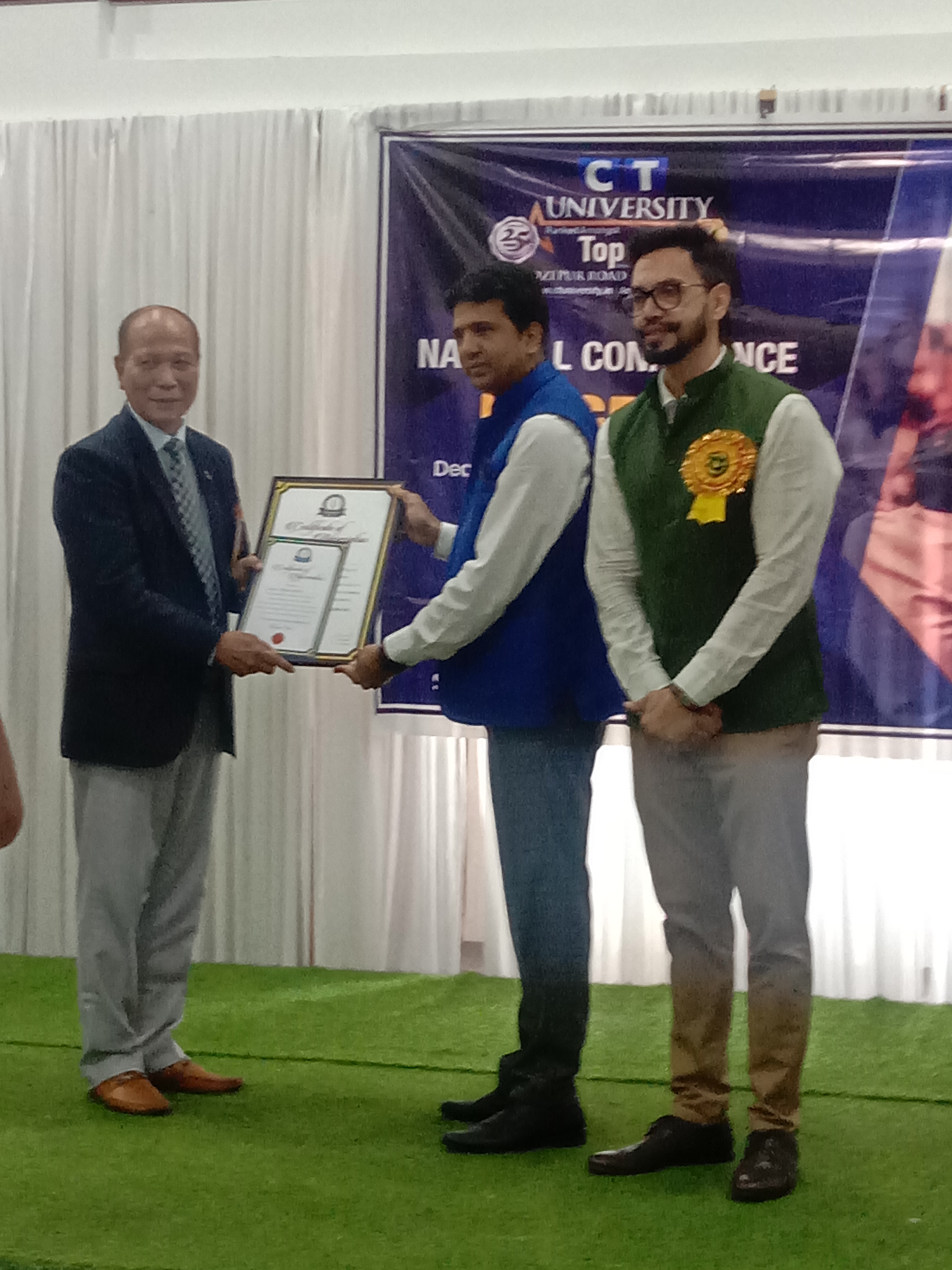 In a function organised by the university being felicitated for the best teacher award, a glimpse of certificate received. image